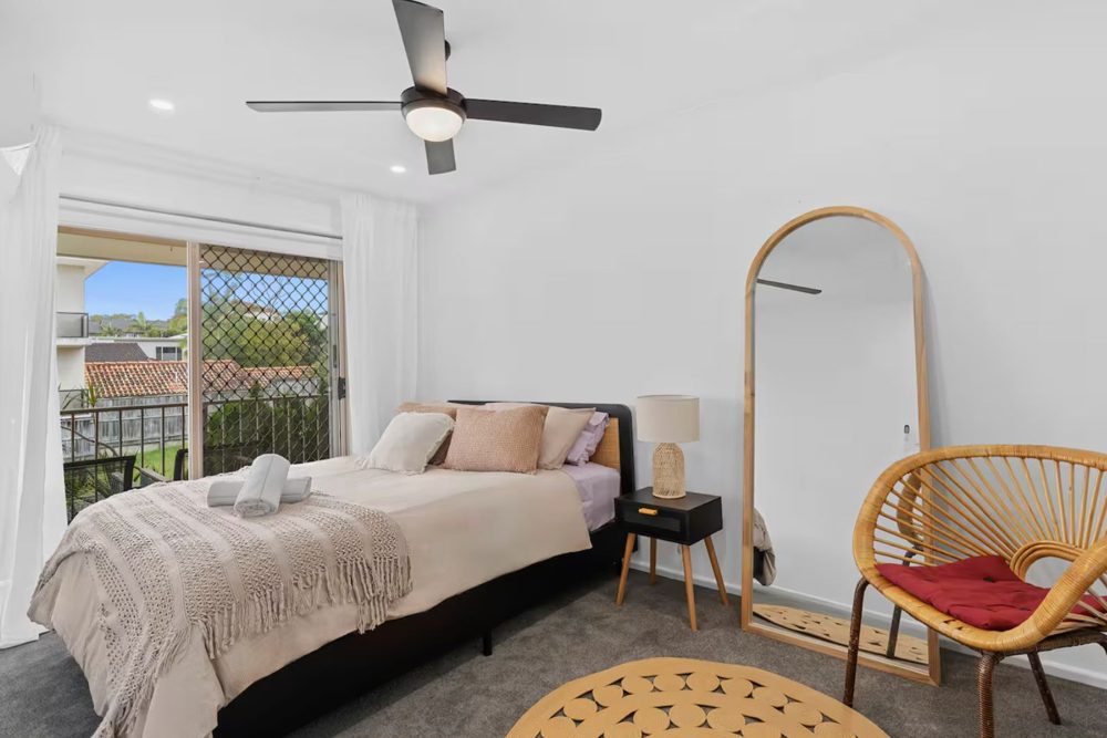 Queen bedroom opening onto a private balcony